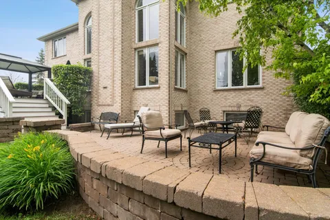 a view of a patio with table and chairs and potted plants