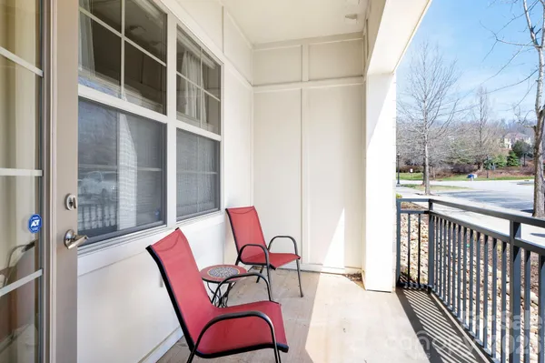 a view of a balcony with furniture