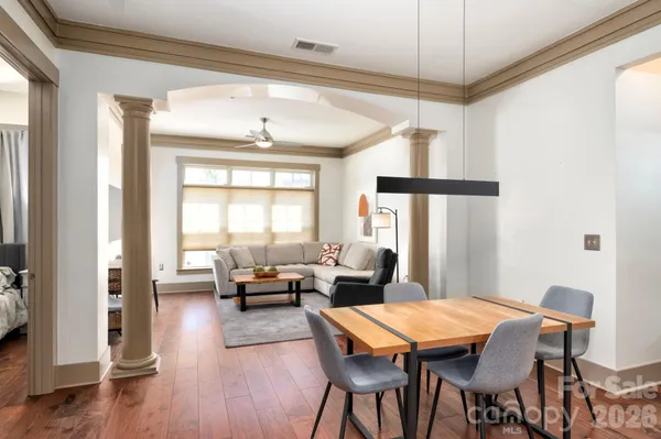 a living room with furniture a table and a chandelier