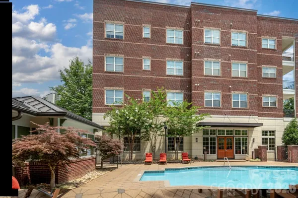 a view of a house with swimming pool and sitting area