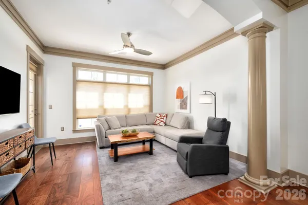 a living room with furniture and wooden floor