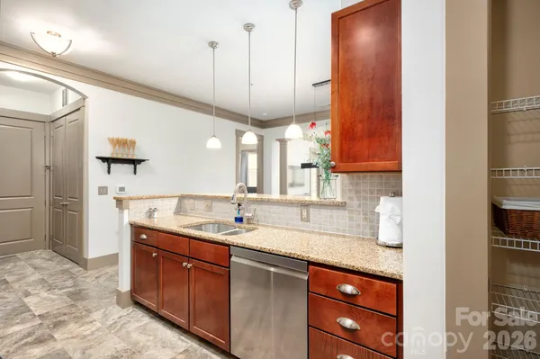 a kitchen with a sink a counter space cabinets and appliances