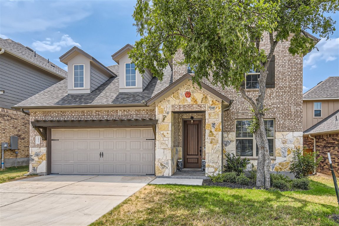 a front view of a house with a garden and plants