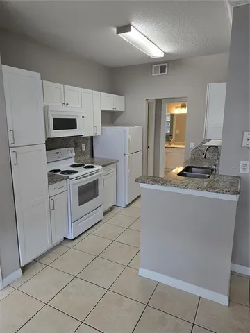 a kitchen with cabinets and appliances
