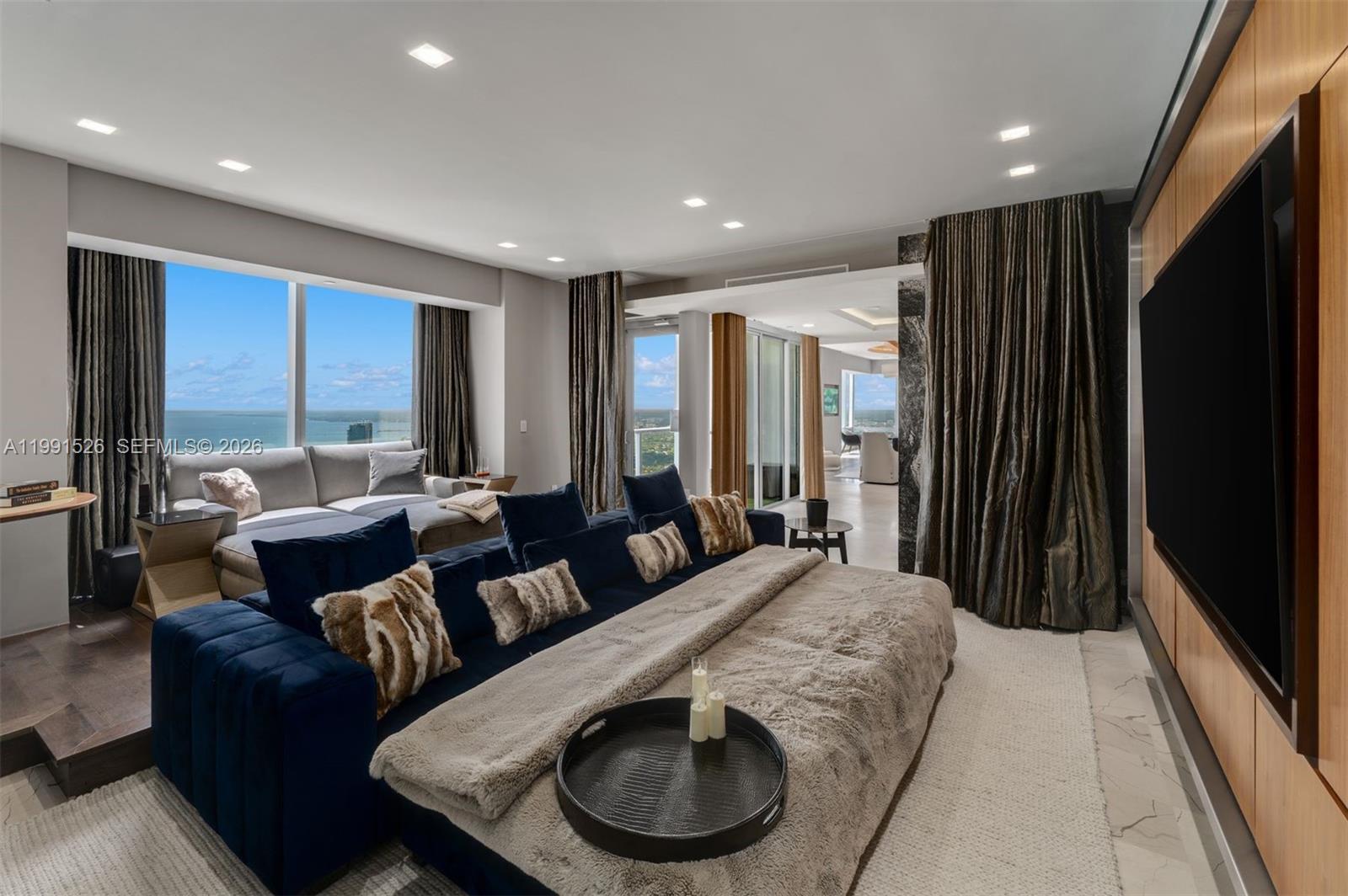 1425 Brickell Avenue, Unit PH2ABCD Miami, FL 33131 - Photo 11 of 20 a living room with furniture and a flat screen tv