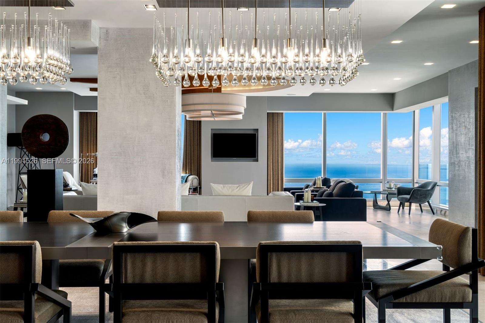 1425 Brickell Avenue, Unit PH2ABCD Miami, FL 33131 - Photo 13 of 20 a dinning room with fireplace and chandelier