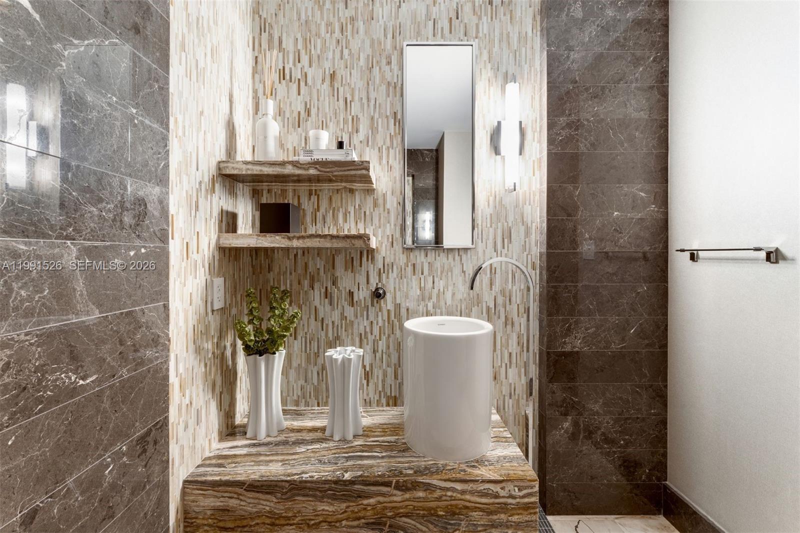 1425 Brickell Avenue, Unit PH2ABCD Miami, FL 33131 - Photo 15 of 20 a view of a bathroom with a sink and a mirror