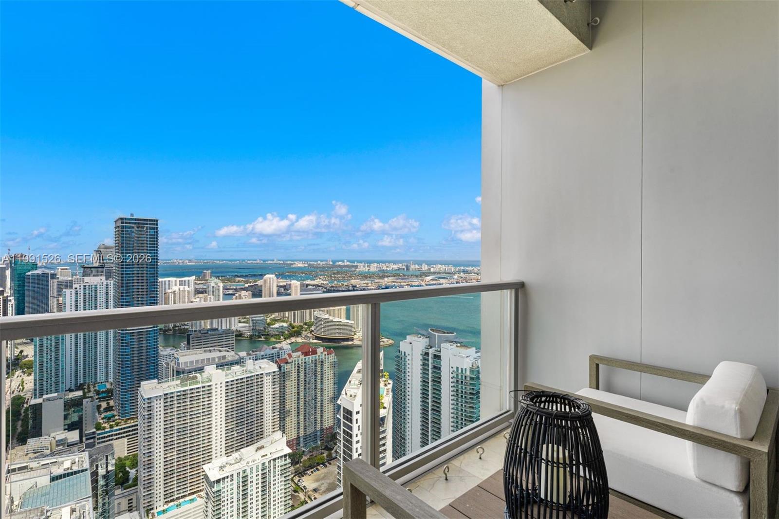 1425 Brickell Avenue, Unit PH2ABCD Miami, FL 33131 - Photo 17 of 20 a view of a balcony with two chairs and a table