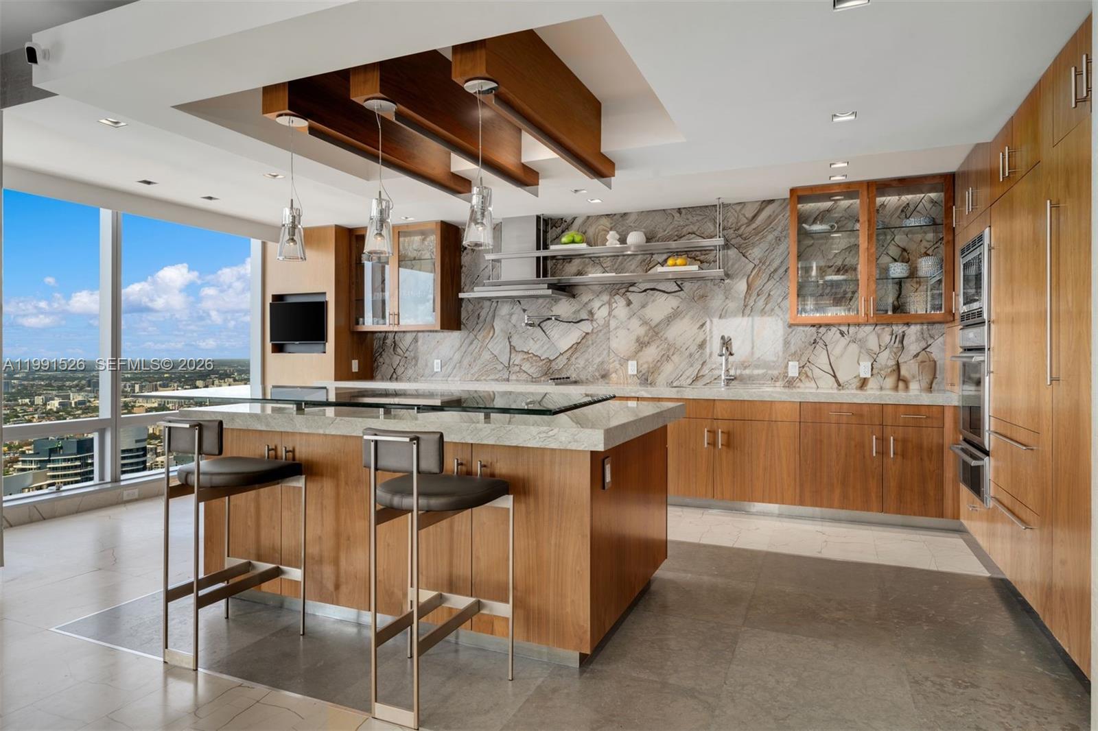 1425 Brickell Avenue, Unit PH2ABCD Miami, FL 33131 - Photo 5 of 20 a kitchen with a sink a counter top space cabinets and stainless steel appliances