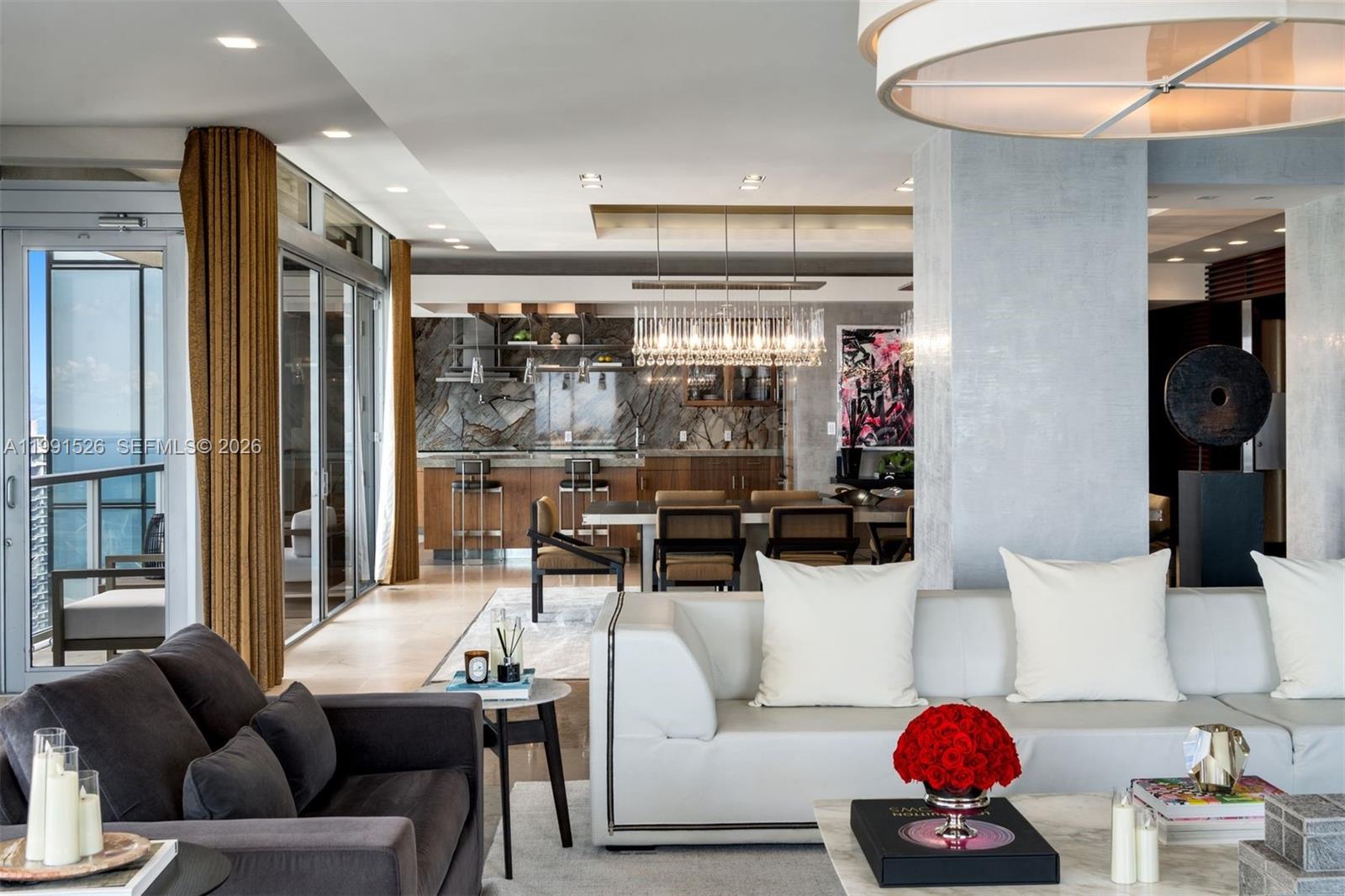 1425 Brickell Avenue, Unit PH2ABCD Miami, FL 33131 - Photo 6 of 20 a living room with furniture and a glass door