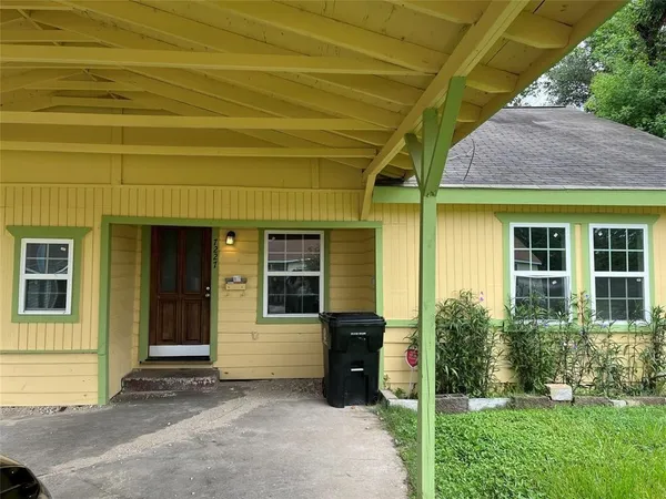 a view of yellow house with front door