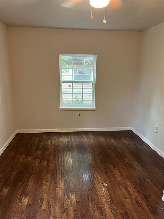 7227 St Augustine Street Houston, TX 77021 - Photo 14 of 20 a view of an empty room with wooden floor and a window