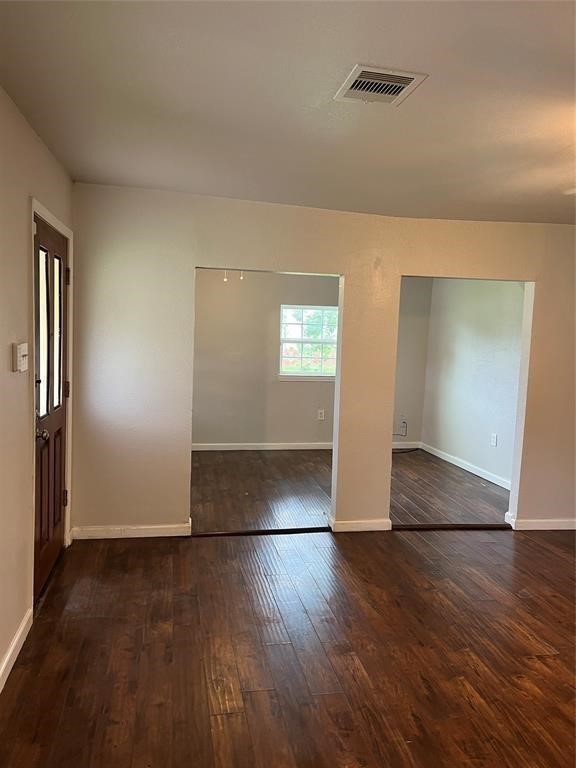 7227 St Augustine Street Houston, TX 77021 - Photo 9 of 20 an empty room with wooden floor and windows