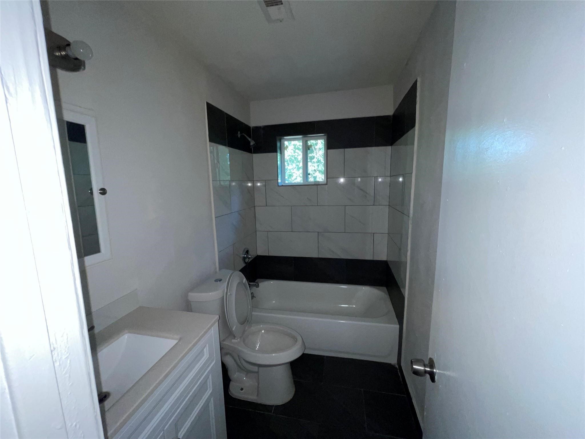 7227 St Augustine Street Houston, TX 77021 - Photo 10 of 20 a bathroom with a sink and toilet