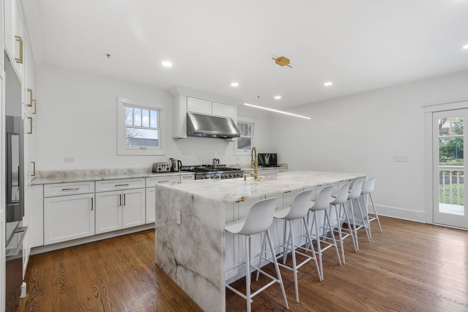 539 South Cook Street Barrington, IL 60010 - Photo 3 of 25 a kitchen with stainless steel appliances white cabinets and wooden floor
