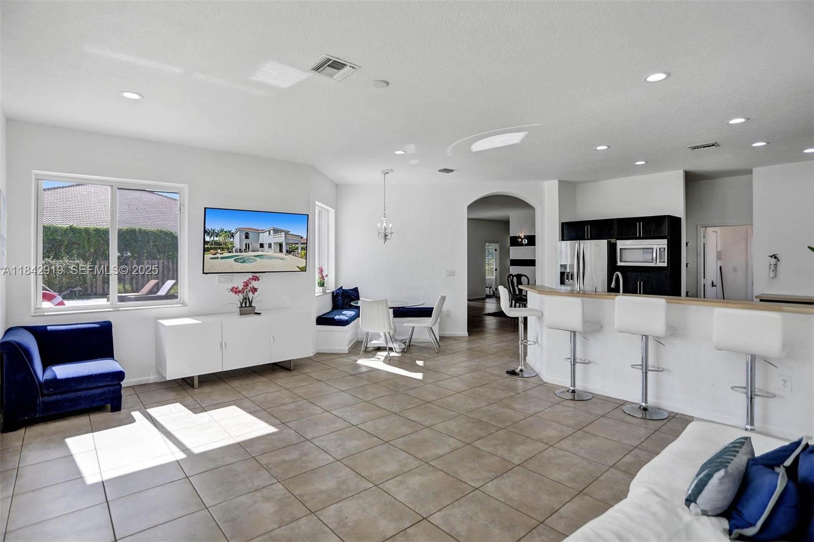 721 Ranch Road Weston, FL 33326 - Photo 38 of 38 a living room with furniture and a large window