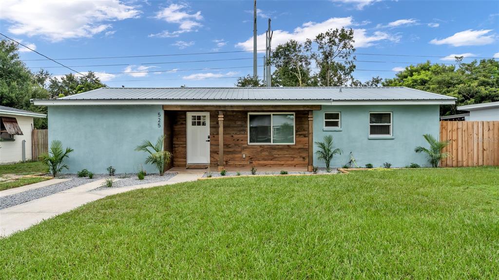 a backyard of a house with table and chairs