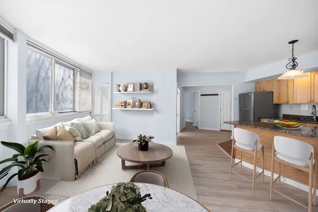 a living room with furniture a rug and a large window