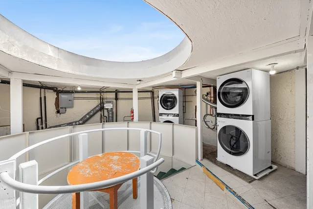 a view of a kitchen with a sink and a washer dryer