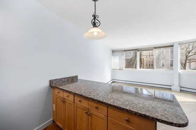 a kitchen with granite countertop cabinets and window