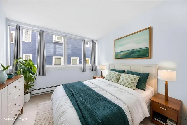 a bedroom with bed and a window