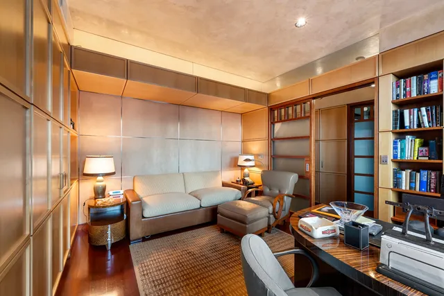 a living room with furniture and floor to ceiling window