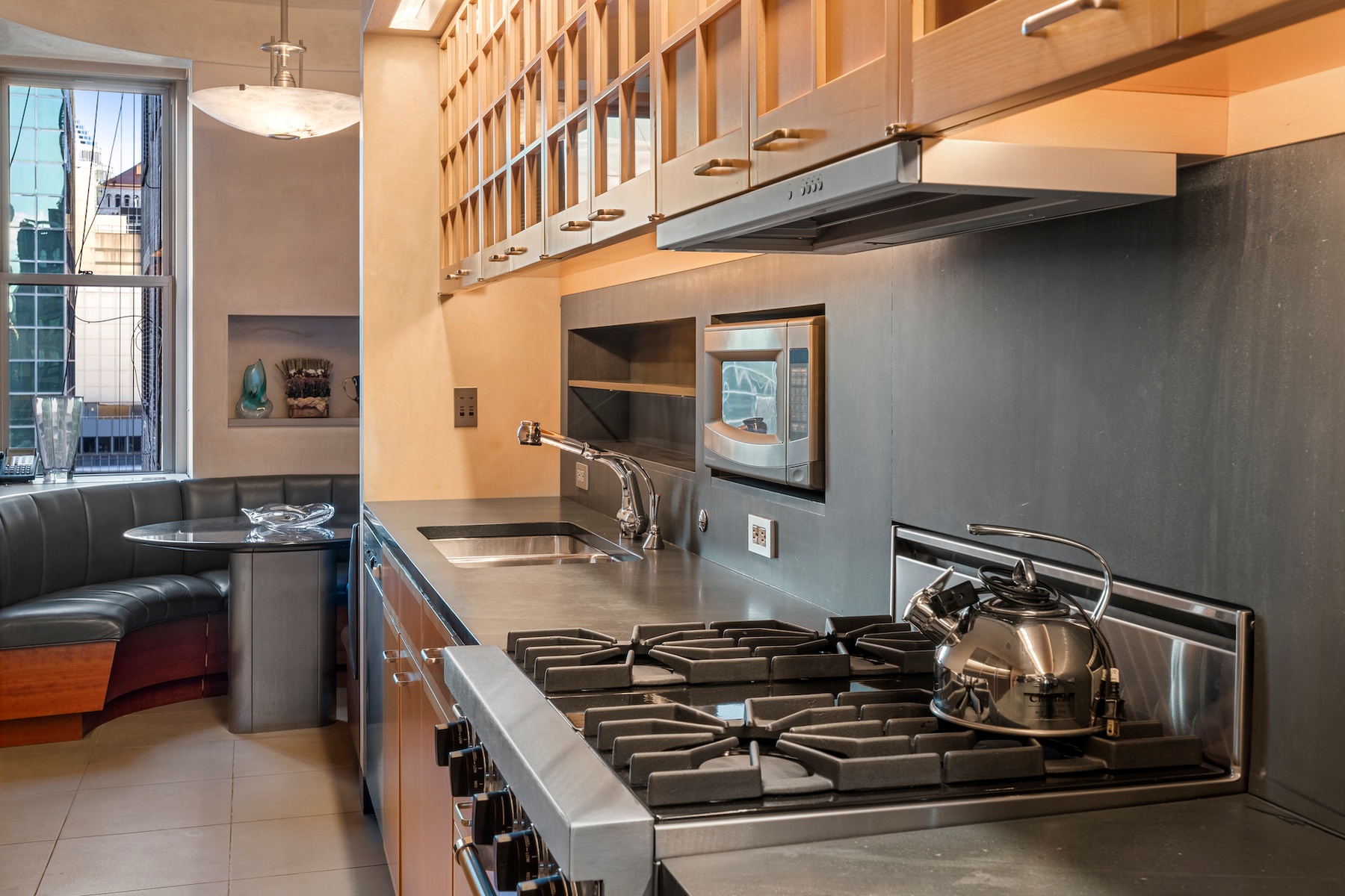 781 5th Avenue, Unit 2001 Manhattan, NY 10022 - Photo 15 of 19 a kitchen with a stove and a sink