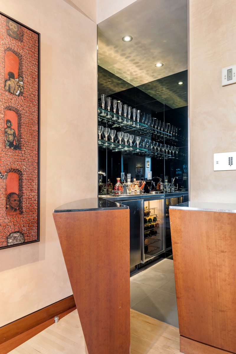 781 5th Avenue, Unit 2001 Manhattan, NY 10022 - Photo 4 of 19 a room with table and chairs