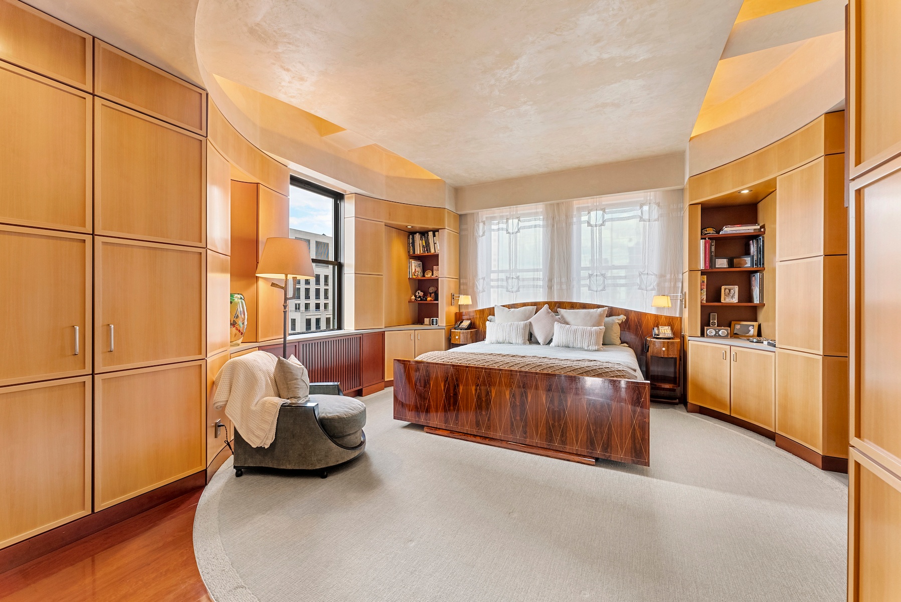 781 5th Avenue, Unit 2001 Manhattan, NY 10022 - Photo 8 of 19 a spacious bedroom with a bed and a window