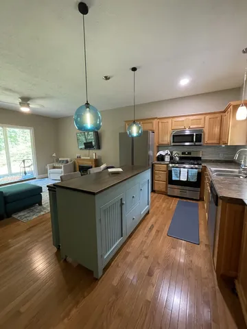 a living room with furniture and kitchen view