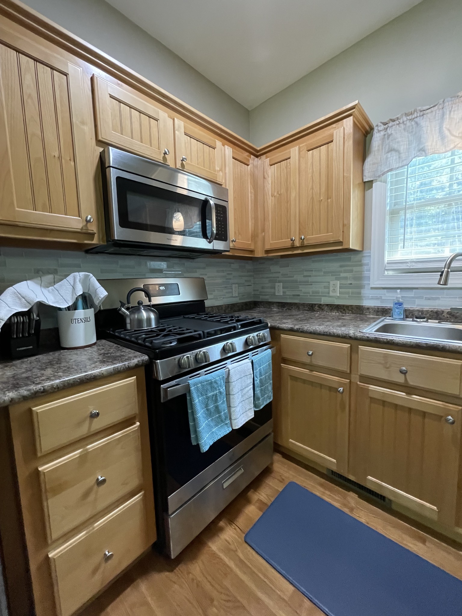 1751 Excalibur Trail Cedar Grove, TN 38321 - Photo 13 of 47 a kitchen with stainless steel appliances granite countertop a stove a microwave and cabinets