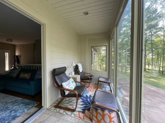 a living room with furniture and a floor to ceiling window