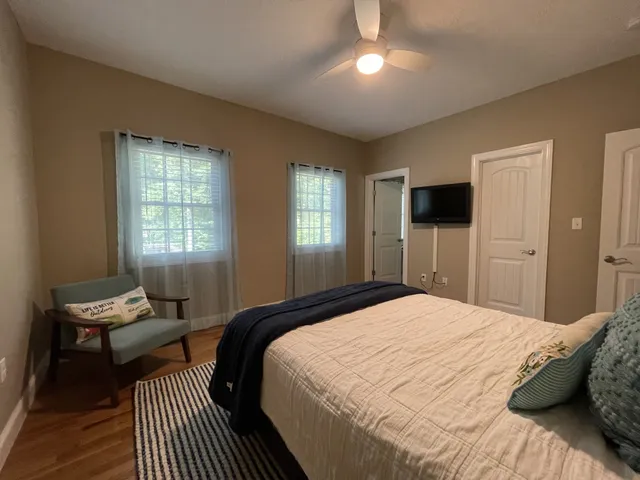 a bedroom with a bed and wooden floor