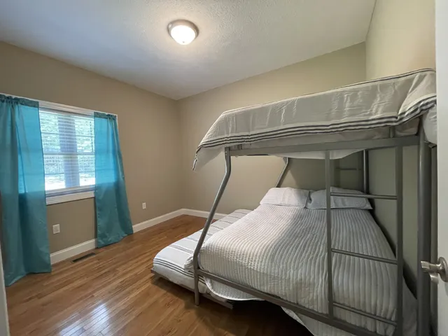 a bedroom with a bed and window