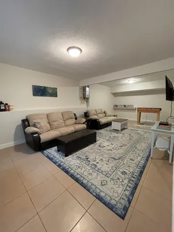 a living room with lots of furniture and a rug