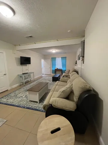 a living room with furniture and a rug