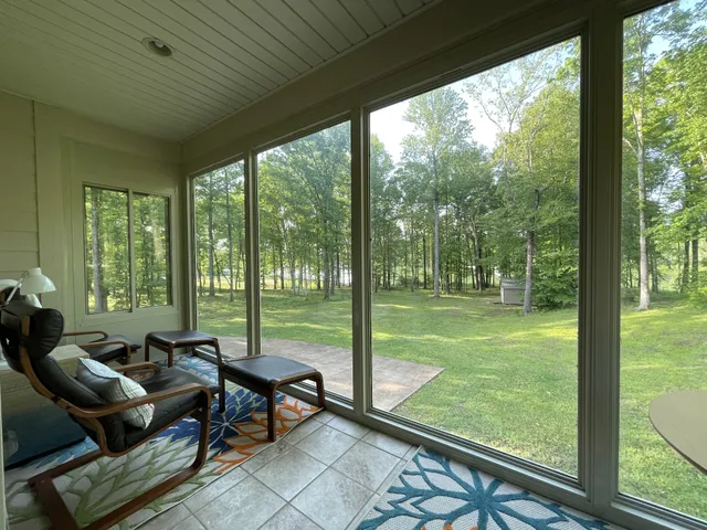 a kitchen with stainless steel appliances granite countertop a stove top oven a sink dishwasher a refrigerator and white cabinets with wooden floor