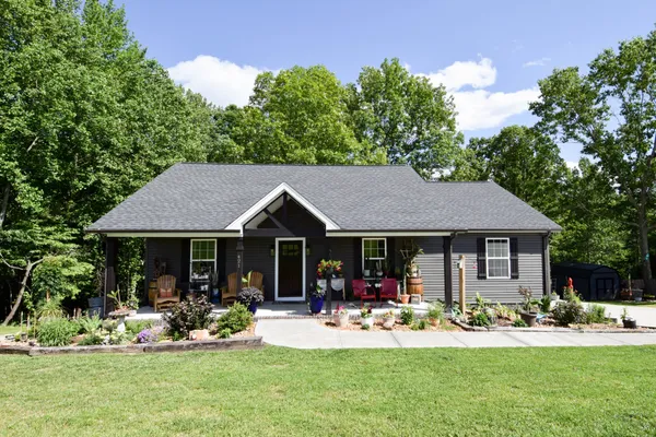 a front view of a house with swimming pool having outdoor seating