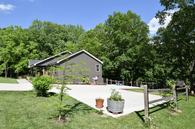 a view of house with backyard and sitting area