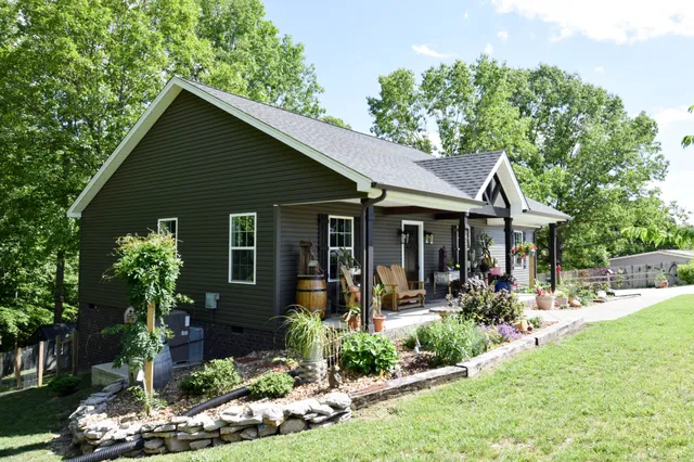 a front view of a house with a yard table and chairs