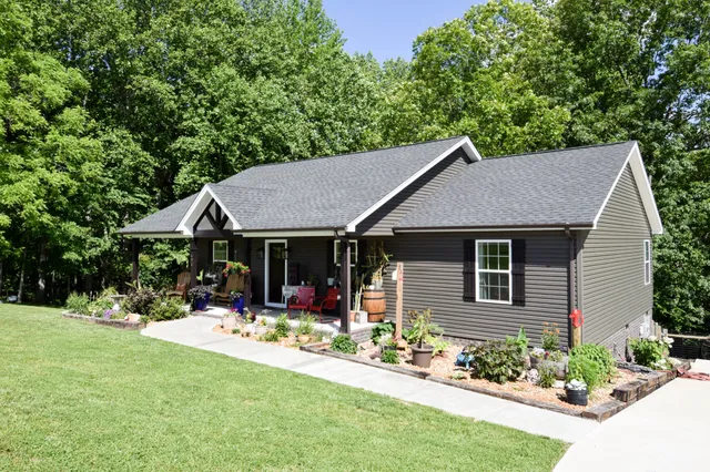 a view of a house with sitting area and potted plants