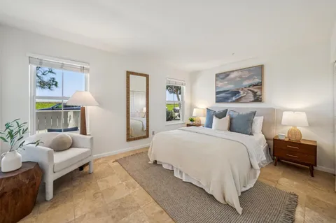 a bedroom with bed and a couch