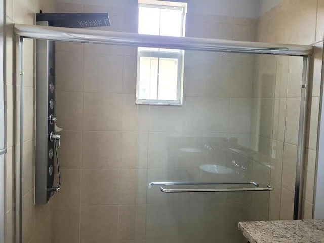 a bathroom with a glass shower door