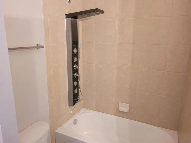 a bathroom with a white bath tub and a shower