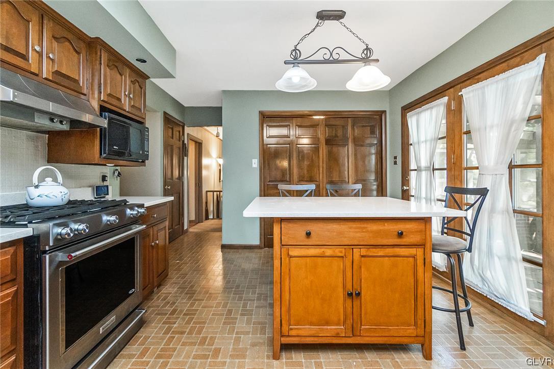 7116 Linden Road Lower Macungie Township, PA 18062 - Photo 12 of 41 a kitchen with stainless steel appliances granite countertop a stove and a refrigerator