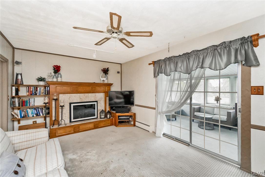 7116 Linden Road Lower Macungie Township, PA 18062 - Photo 17 of 41 a living room with furniture a fireplace and a ceiling fan