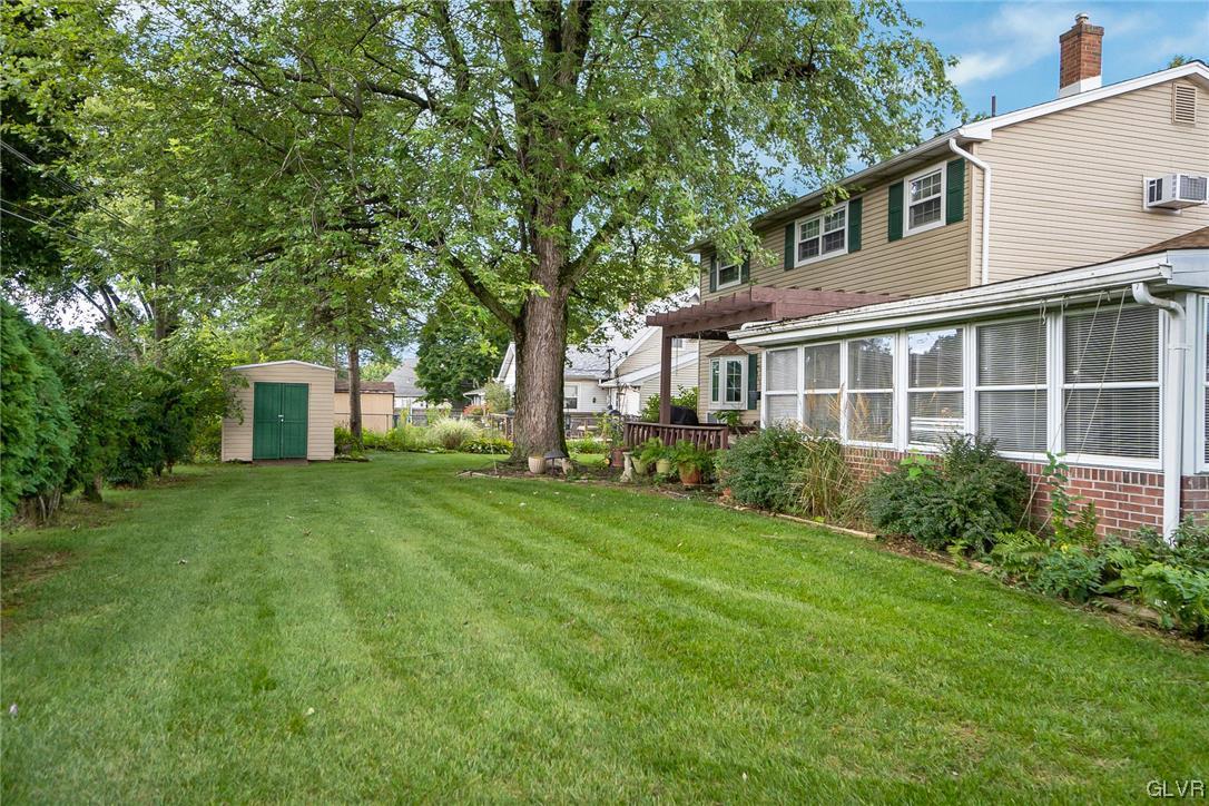 7116 Linden Road Lower Macungie Township, PA 18062 - Photo 2 of 41 a front view of a house with a yard and trees