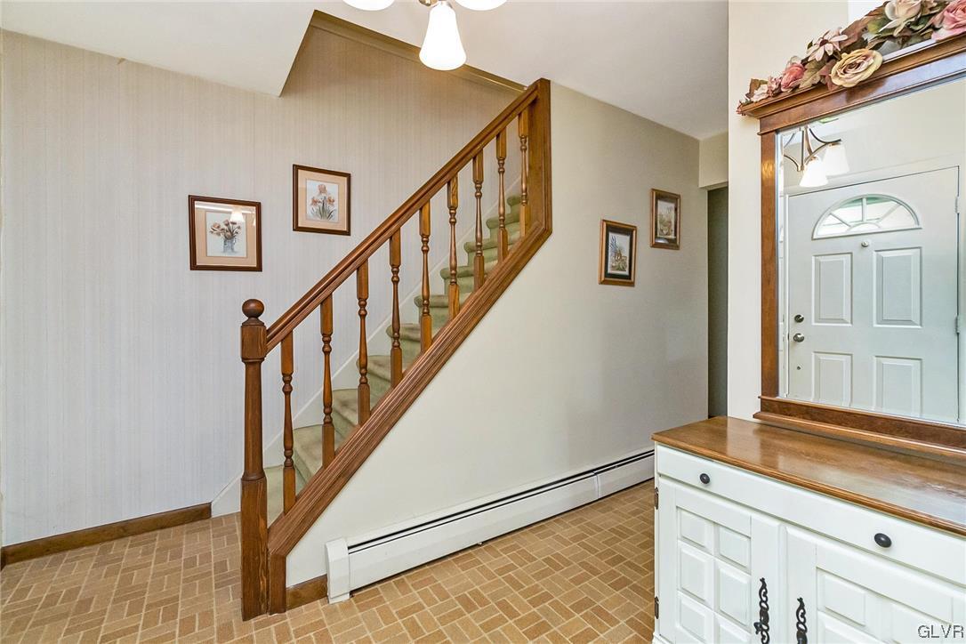 7116 Linden Road Lower Macungie Township, PA 18062 - Photo 26 of 41 a view of a hallway with wooden floor and staircase