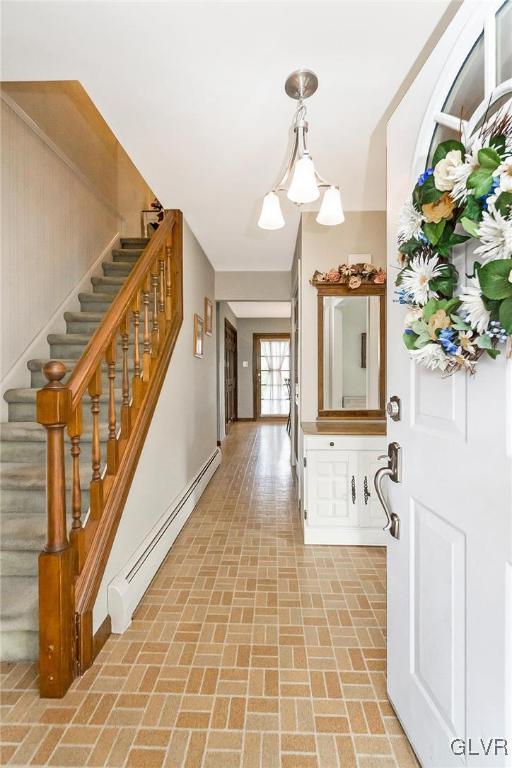 7116 Linden Road Lower Macungie Township, PA 18062 - Photo 3 of 41 a view of a hallway with wooden floor and chandelier