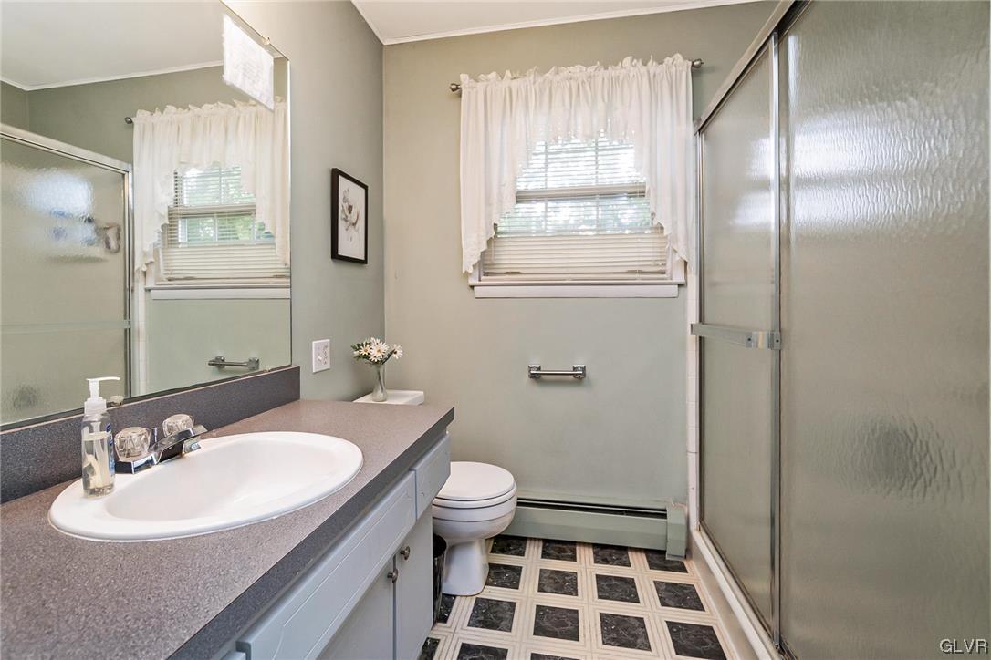 7116 Linden Road Lower Macungie Township, PA 18062 - Photo 35 of 41 a bathroom with a sink toilet a mirror and shower